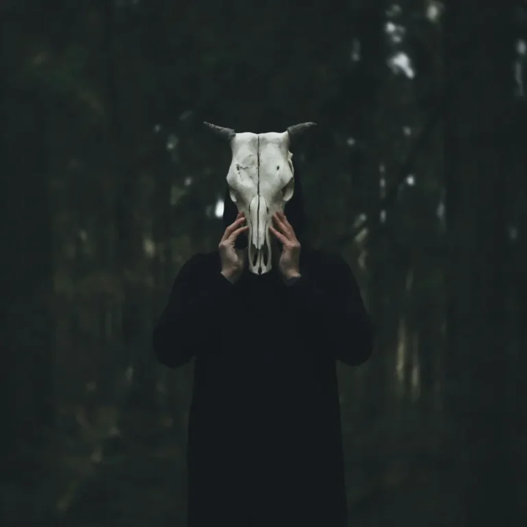 A Chaos Magician wearing a goat's skull in the woods