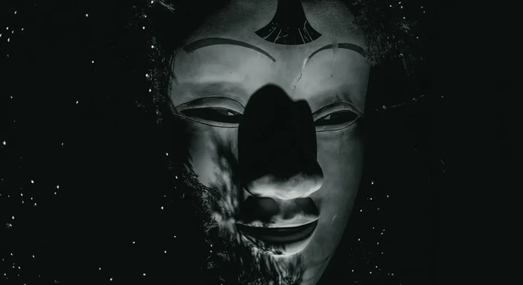 Scary mask emerging from the darkness, symbolizing the demon Choronzon - a magickal shadow-self