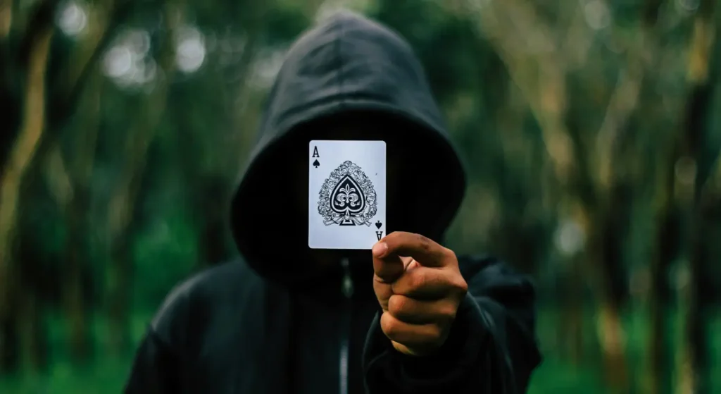 Chaote in the forest, holding the Ace card, symbolizing victory and control